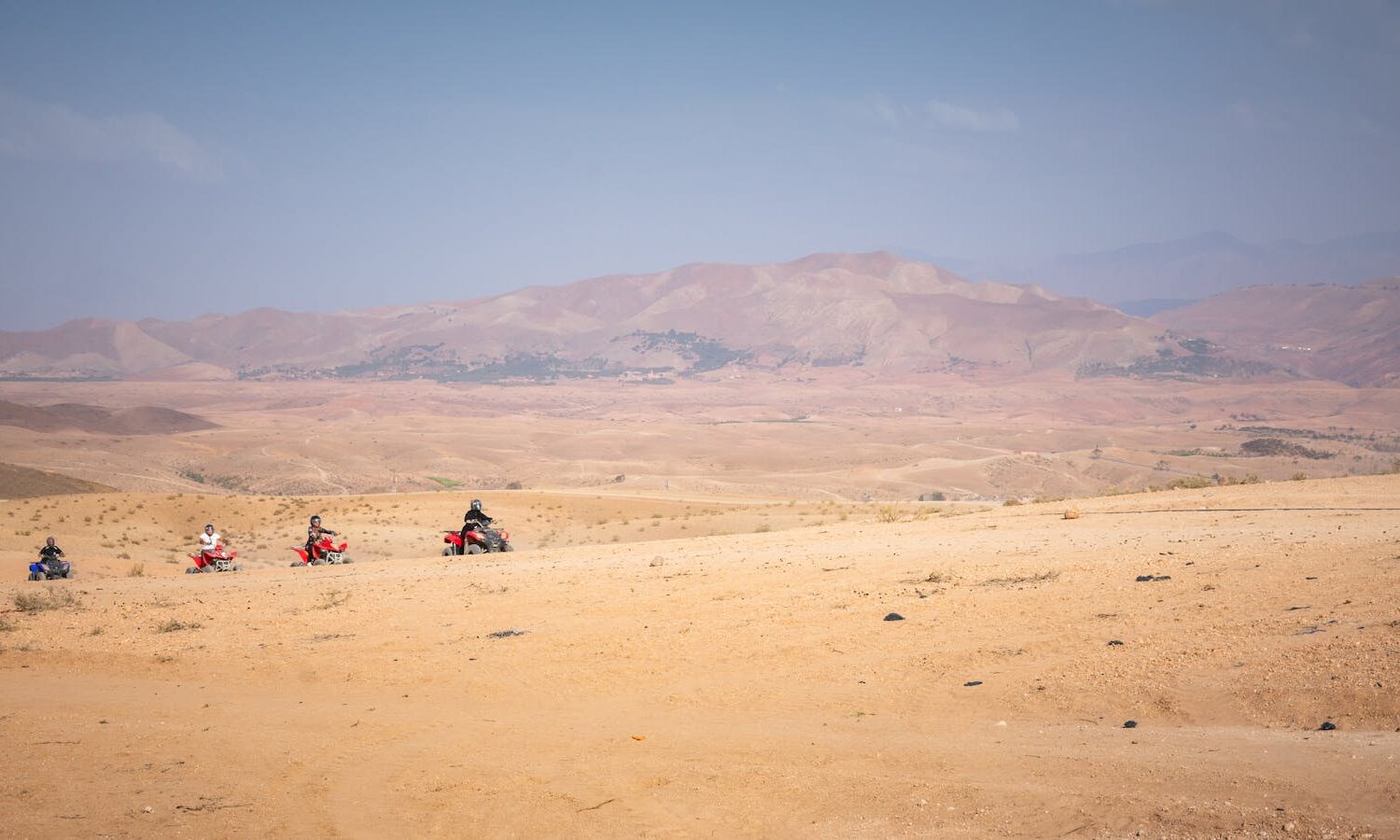 Group of quad bikers exploring the vast Agafay desert near Marrakech, Morocco.