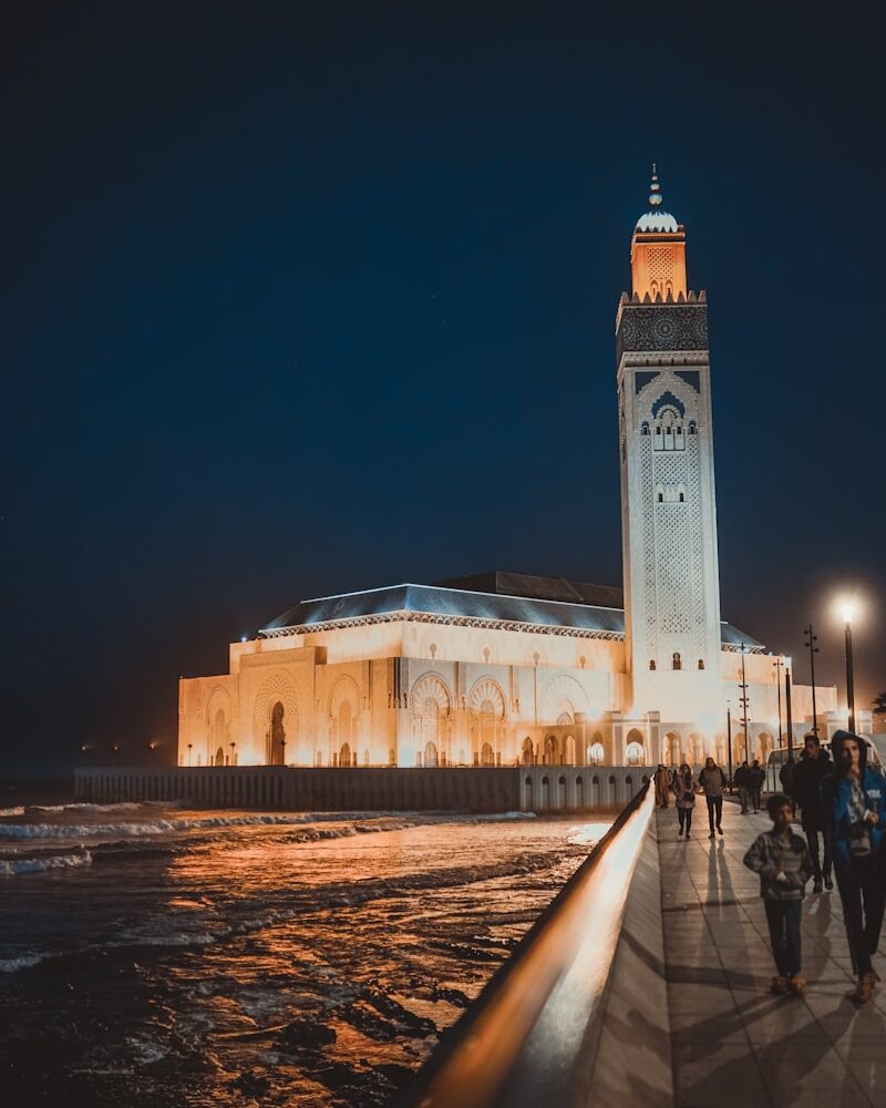 people walking near brown concrete building during night time