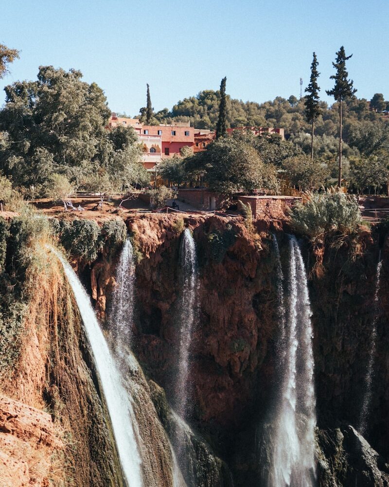 a large waterfall with a bridge above it