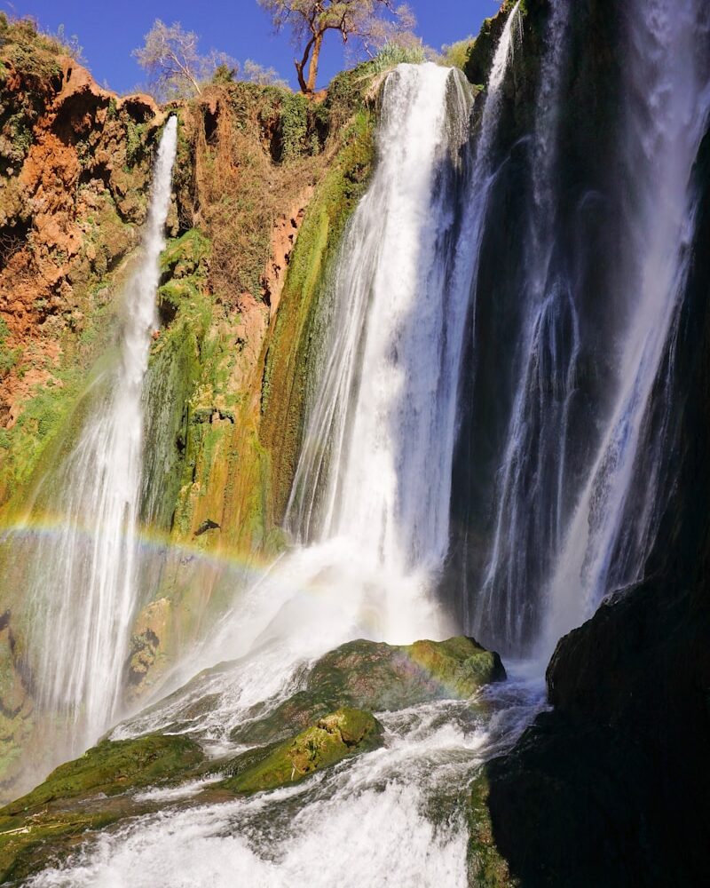 waterfalls on brown rocky mountain during daytime