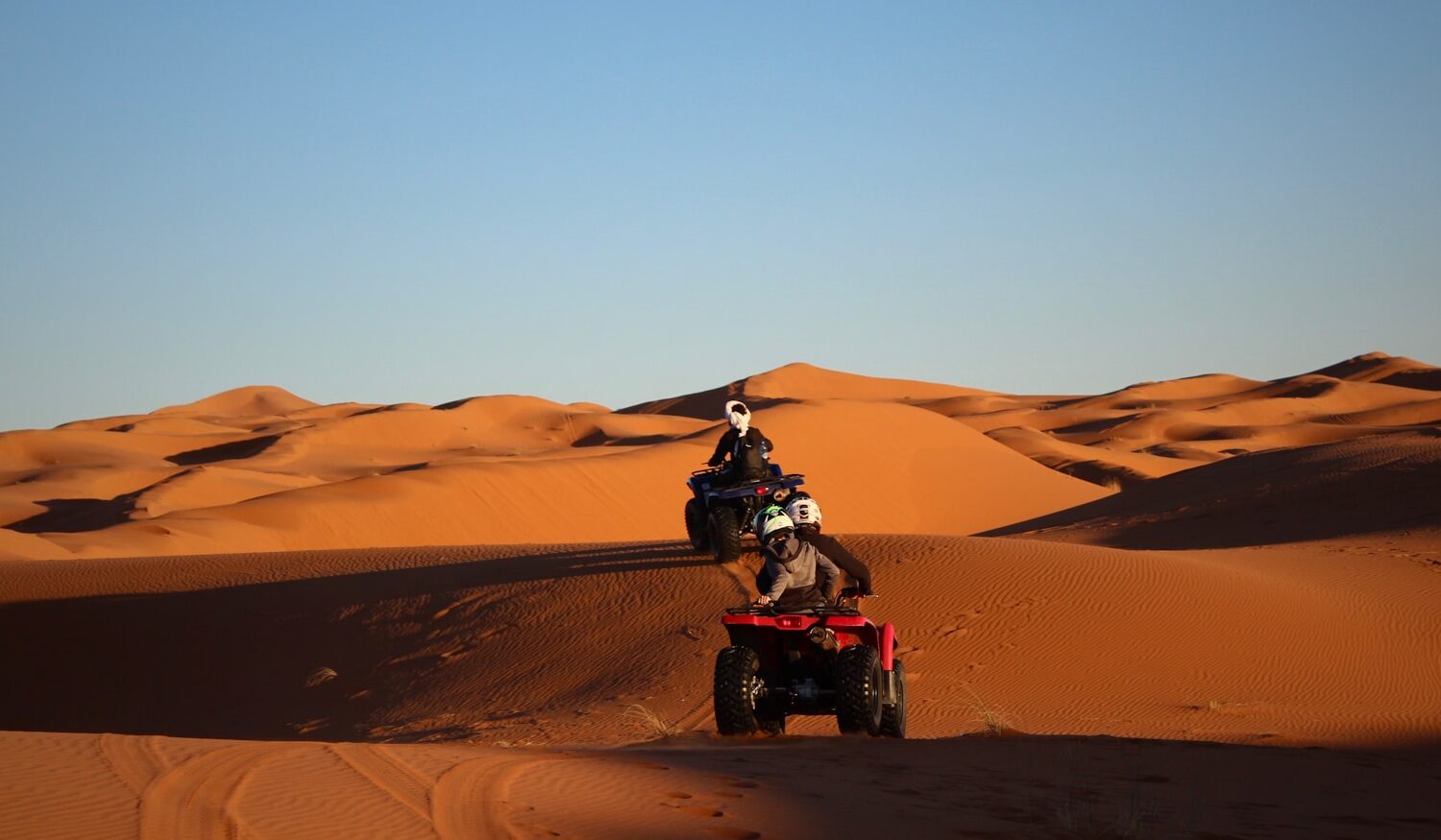 man riding atv on desert during daytime