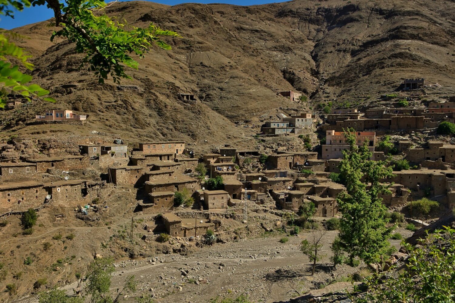 A village in a mountainous area with mountains in the background